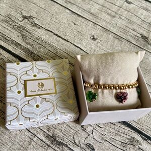 New in box. Stretchy beaded bracelet with 5 millefiori heart charms in colors